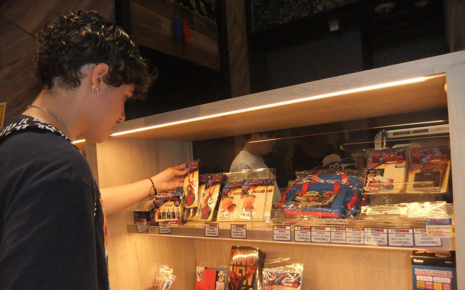 Camryn Rosa looking at Spiderman merchandises at the theater gift shop.